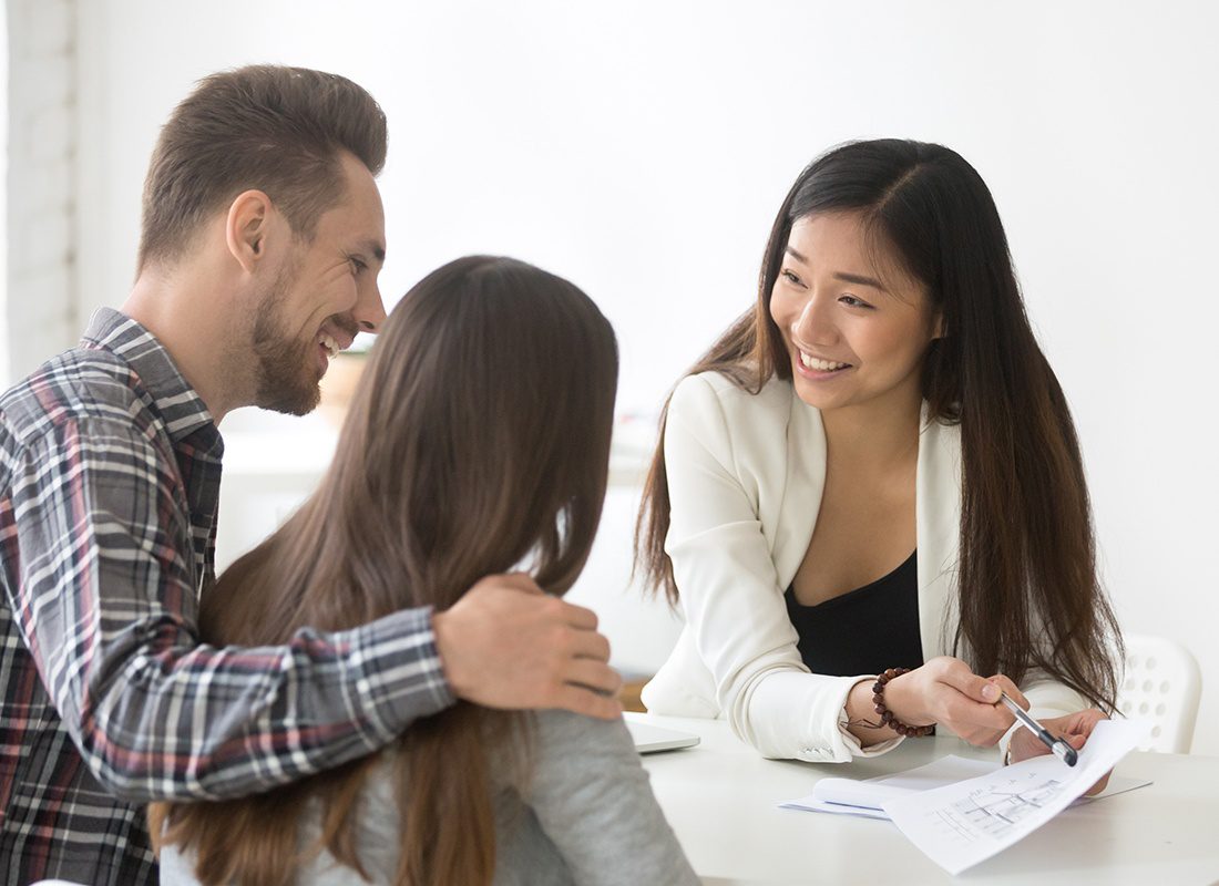 Contact - Female Agent Sits With a Couple to Review Documents